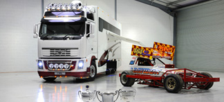 A truck next to a racing car branded with J Davidson